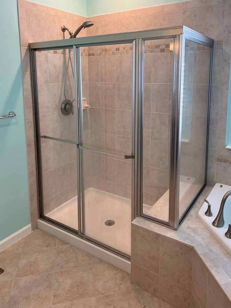 Framed three-piece shower enclosure with metal frames, before replacement