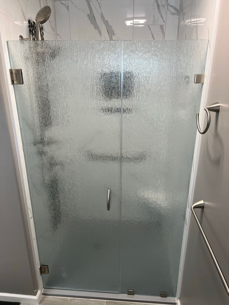 Shower door made of textured rain glass with brushed nickel hardware